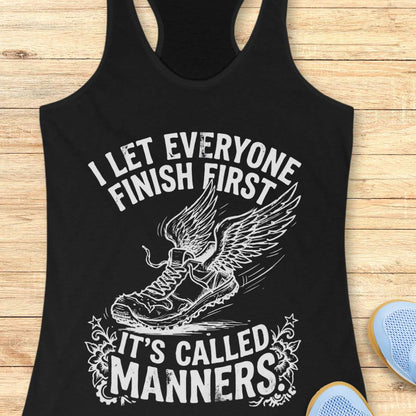 Black tank top with white graphic and text on a wooden surface