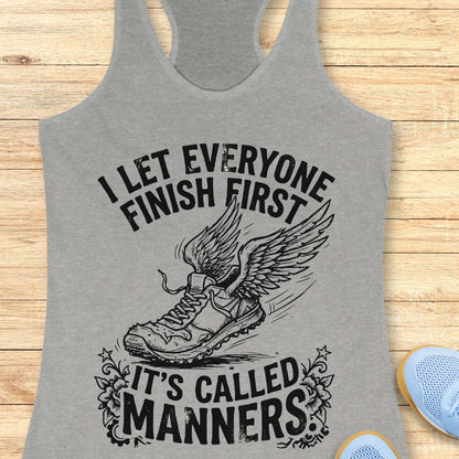 Gray tank top with a graphic and text on a wooden surface