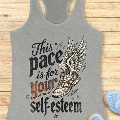 Gray tank top with motivational quote and shoe graphic on a wooden surface