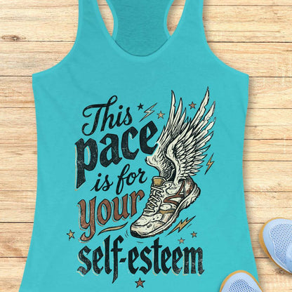 Turquoise tank top with motivational quote and shoe graphic on a wooden surface