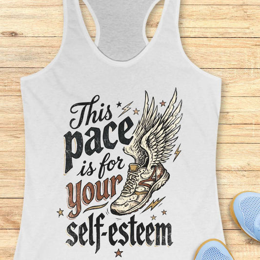 Gray tank top with motivational quote and shoe graphic on a wooden surface
