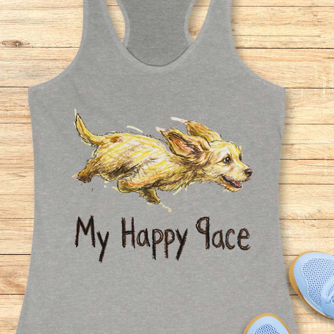 Gray tank top with a dog illustration and 'My Happy Place' text on a wooden surface