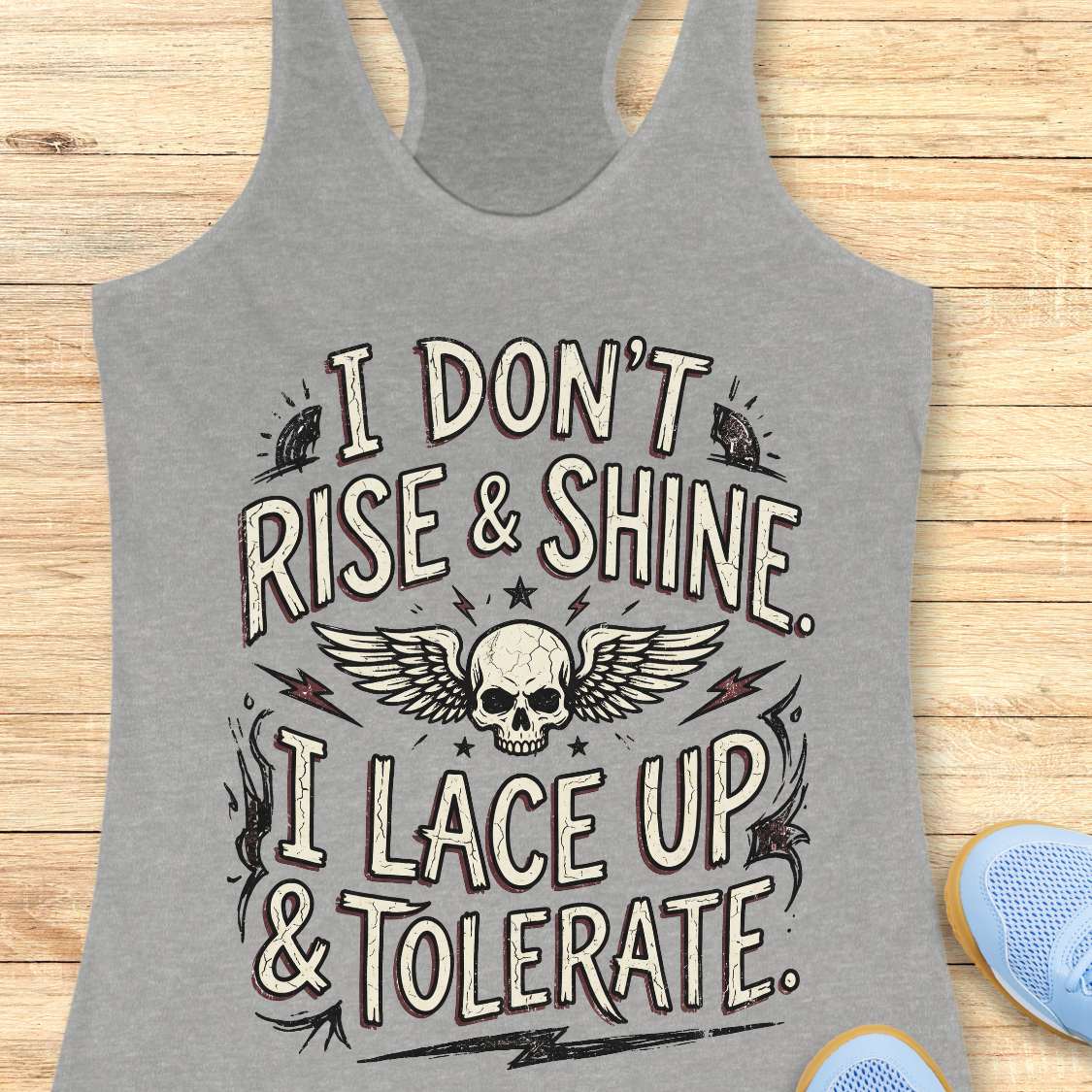 Gray tank top with a skull design and text on a wooden surface