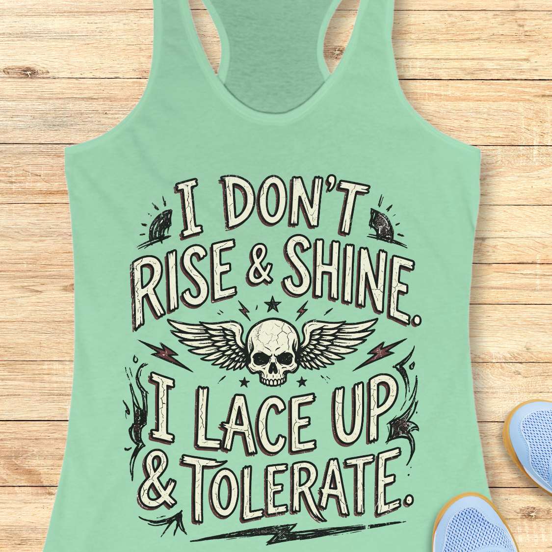 Mint green tank top with skull design and text on a wooden surface