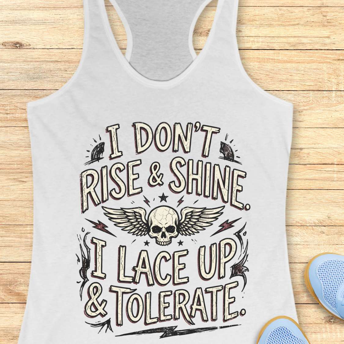 white tank top with motivational text design on a wooden surface