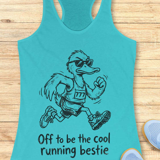 Turquoise tank top with a cartoon ostrich running and sunglasses on, text 'Off to be the cool running bestie' on a wooden surface.