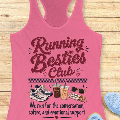 Pink tank top with 'Running Besties Club' text and graphics on a wooden surface