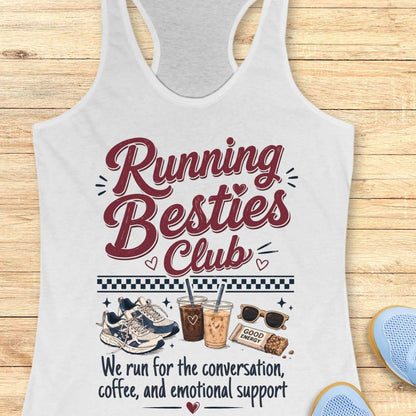 White tank top with 'Running Besties Club' text and graphics on a wooden surface