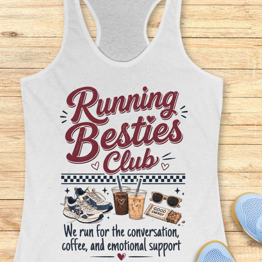 White tank top with 'Running Besties Club' text and graphics on a wooden surface