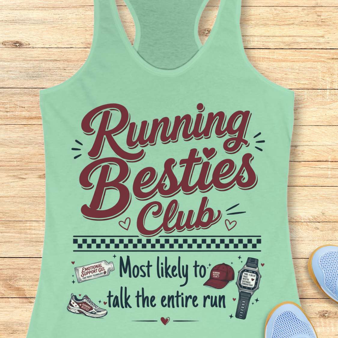 Mint green tank top with 'Running Besties Club' text and graphics on a wooden surface.