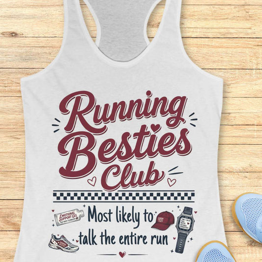 White tank top with 'Running Besties Club' text and graphics on a wooden surface