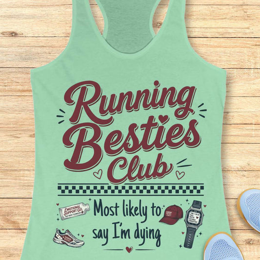 Light green tank top with 'Running Besties Club' text and graphics on a wooden surface