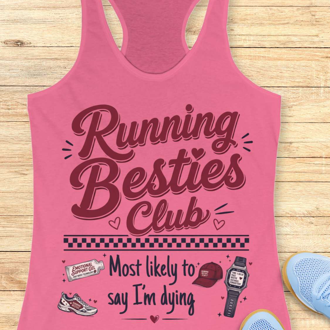 Pink tank top with 'Running Besties Club' text on a wooden surface