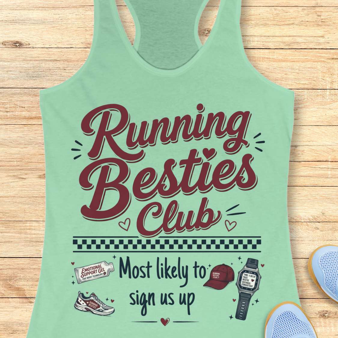 Light green tank top with 'Running Besties Club' text and graphics on a wooden surface