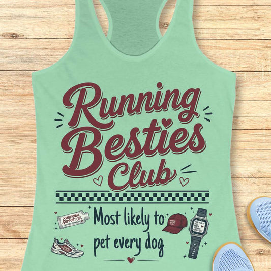 Light green tank top with 'Running Besties Club' text and graphics on a wooden surface