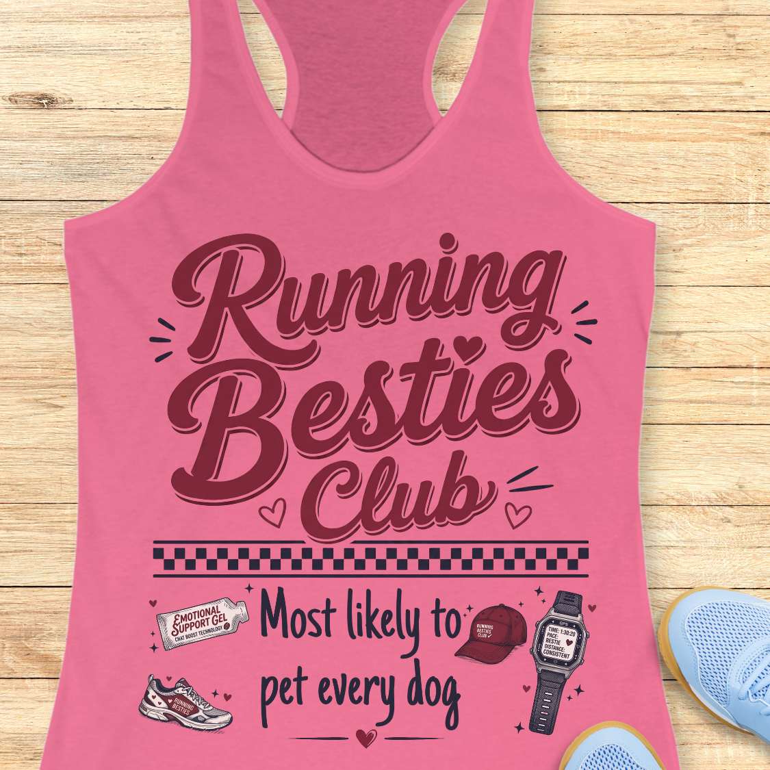 Pink tank top with 'Running Besties Club' text and graphics on a wooden surface