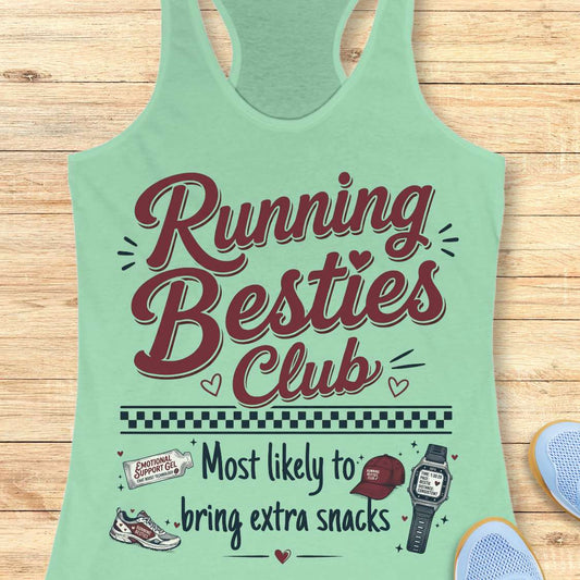 Green tank top with 'Running Besties Club' text and graphics on a wooden surface