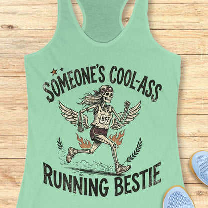 Light green tank top with skeleton design and text on a wooden surface