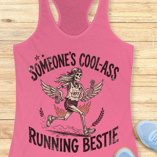 Pink tank top with skeleton design and text on a wooden surface