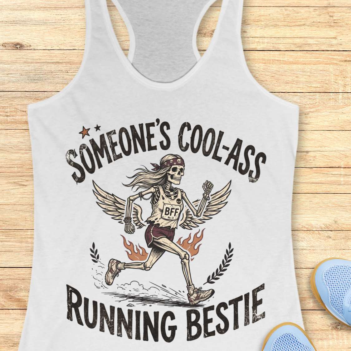 white tank top with skeleton graphic and text on a wooden surface