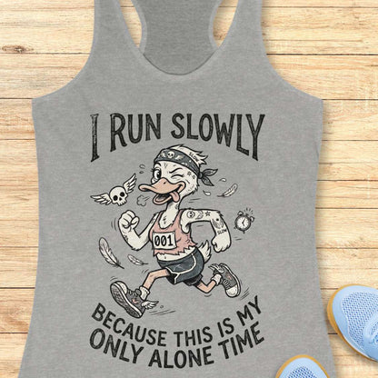 Gray tank top with cartoon character and text 'I Run Slowly Because This is My Only Alone Time' on a wooden surface.