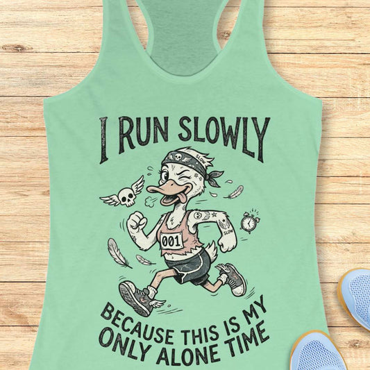 Mint green tank top with cartoon duck design and text - I run slowly, because this is my only alone time, on a wooden surface