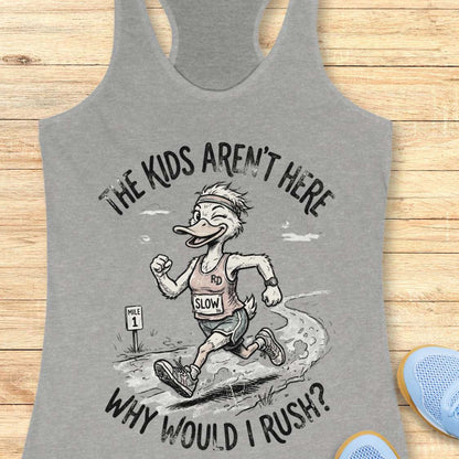 Gray tank top with cartoon character and text - the kids aren't here, why would I rush?, on a wooden surface
