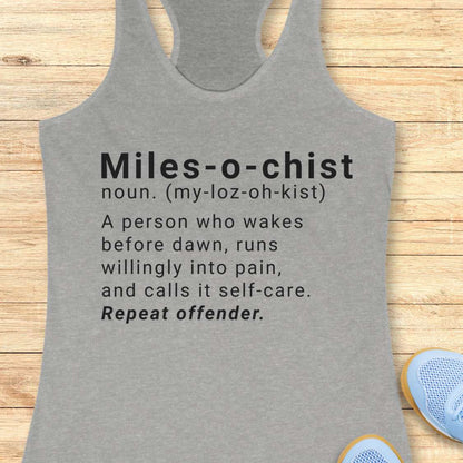 Gray tank top with humorous definition text on a wooden surface