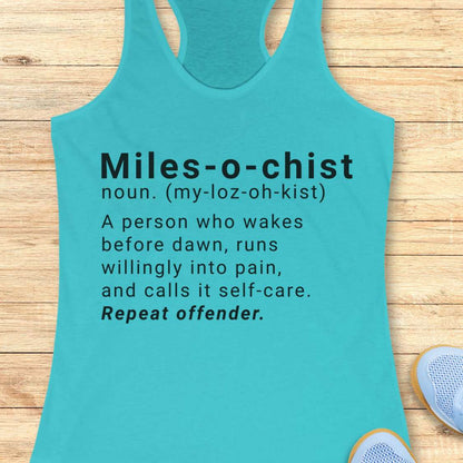 Turquoise tank top with humorous definition text on a wooden surface