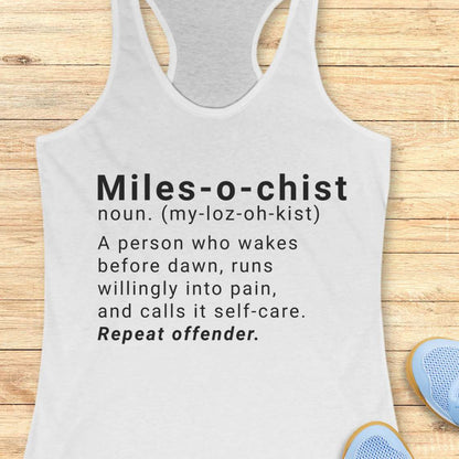 white tank top with humorous text on a wooden surface