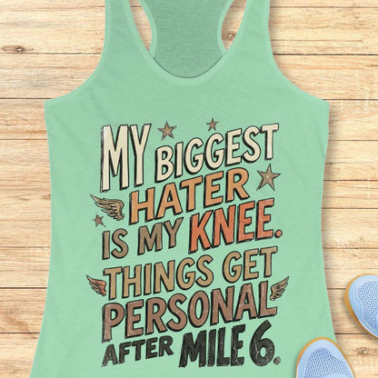 Mint green tank top with motivational text on a wooden surface