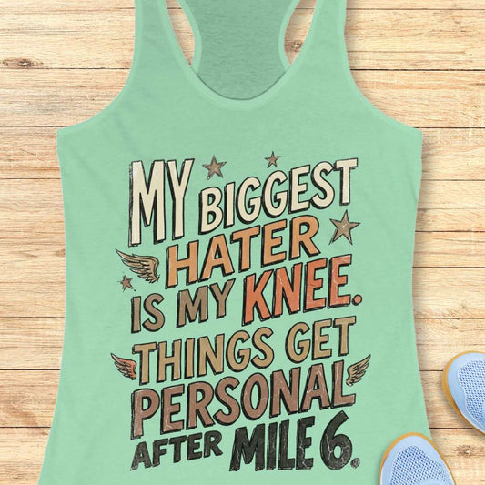 Mint green tank top with motivational text on a wooden surface