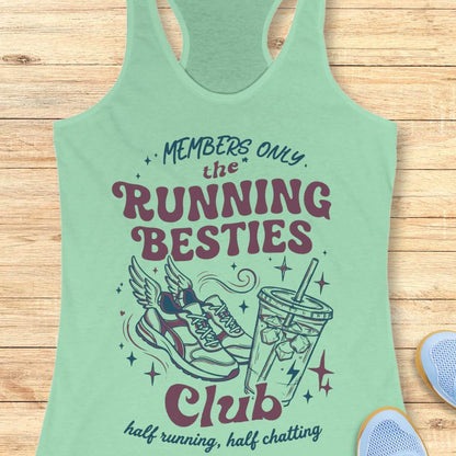 Mint green tank top with 'Running Besties Club' design on a wooden surface