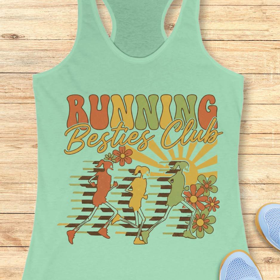 Light green tank top with 'Running Besties Club' design on a wooden surface