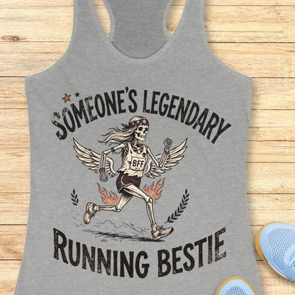 Gray tank top with skeleton design and text someone's legendary running bestie on a wooden surface