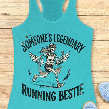 Turquoise tank top with skeleton graphic and text someone's legendary running bestie on a wooden surface