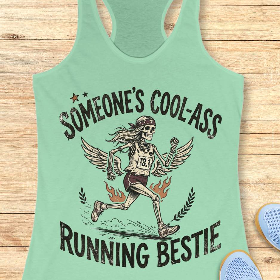 Light green tank top with skeleton graphic and text someone's cool-ass running bestie on a wooden surface