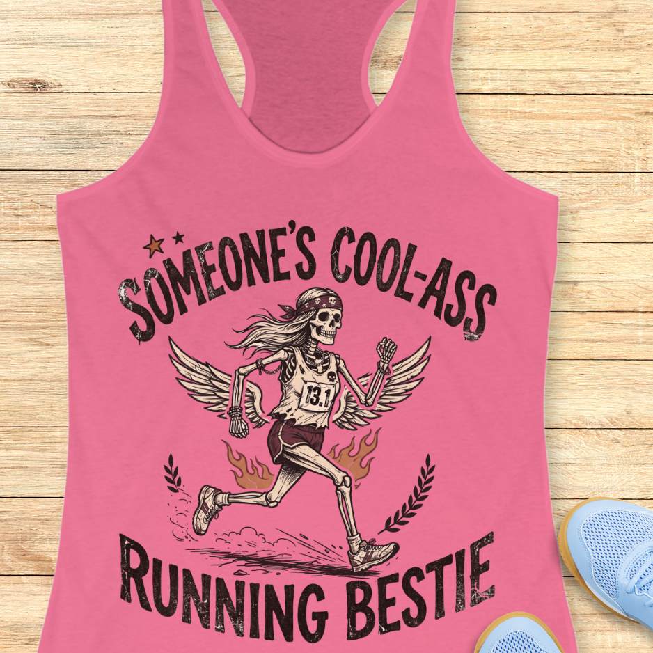 Pink tank top with skeleton graphic and text someone's cool-ass running bestie on a wooden surface