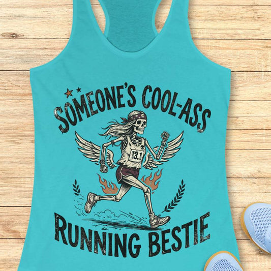 Turquoise tank top with skeleton graphic and text someone's cool-ass running bestie on a wooden surface