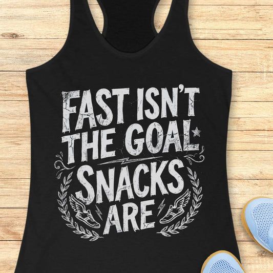 Black tank top with white text fast isn't the goal, snacks are, on a wooden surface