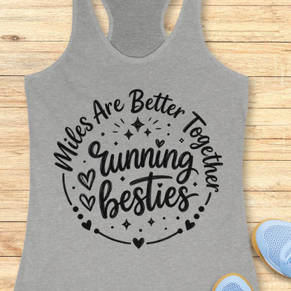 Gray tank top with 'Miles Are Better Running Together, Besties' text on a wooden surface