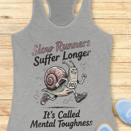 Gray tank top with a snail graphic and text on a wooden surface