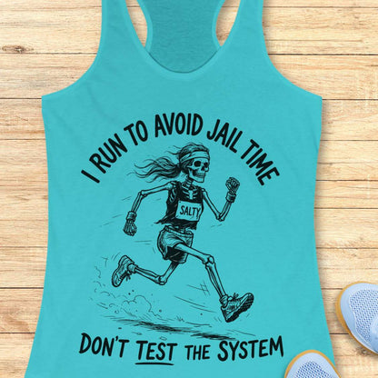 Turquoise tank top with skeleton graphic and text i run to avoid jail time don't test the system  on a wooden surface
