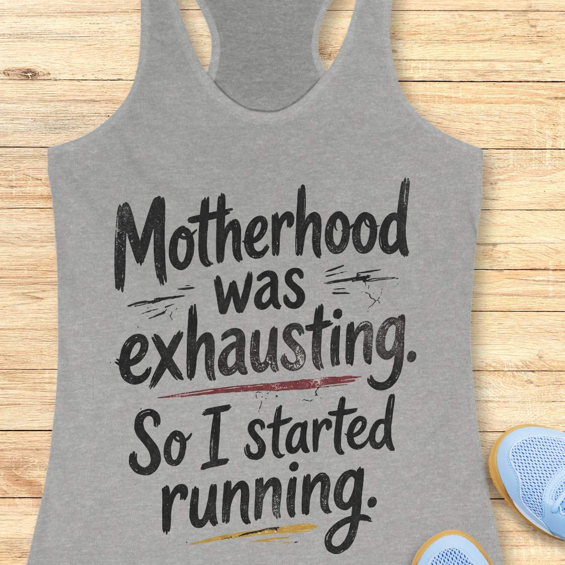 Gray tank top with humorous text motherhood was exhausting. So I started running.  on a wooden surface