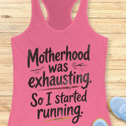 Pink tank top with humorous text motherhood was exhausting. So I started running.  on a wooden surface