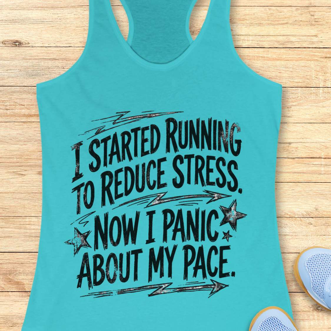 Turquoise tank top with humorous text  I started running to reduce stress. Now I panic about my pace. on a wooden surface