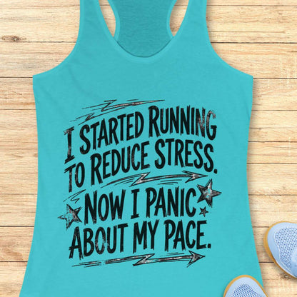 Turquoise tank top with humorous text  I started running to reduce stress. Now I panic about my pace. on a wooden surface