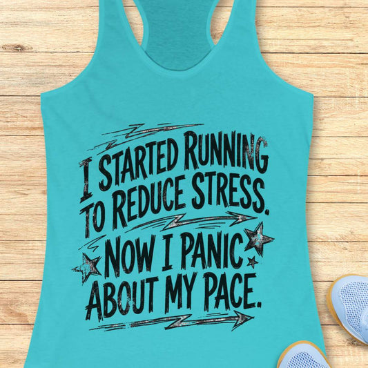 Turquoise tank top with humorous text  I started running to reduce stress. Now I panic about my pace. on a wooden surface