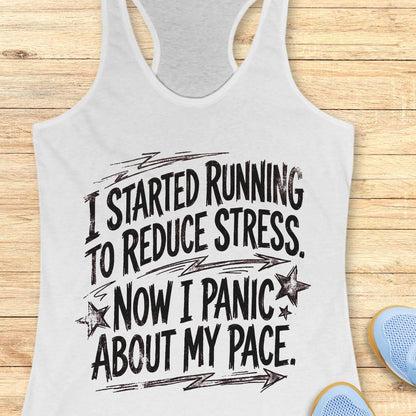 white tank top with humorous running text I started running to reduce stress. Now I panic about my pace.  on a wooden surface