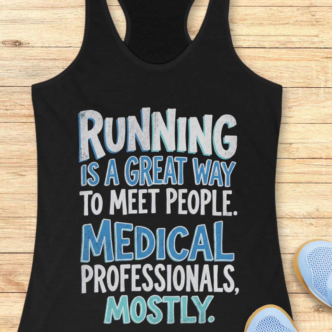 Black tank top with humorous text on a wooden surface